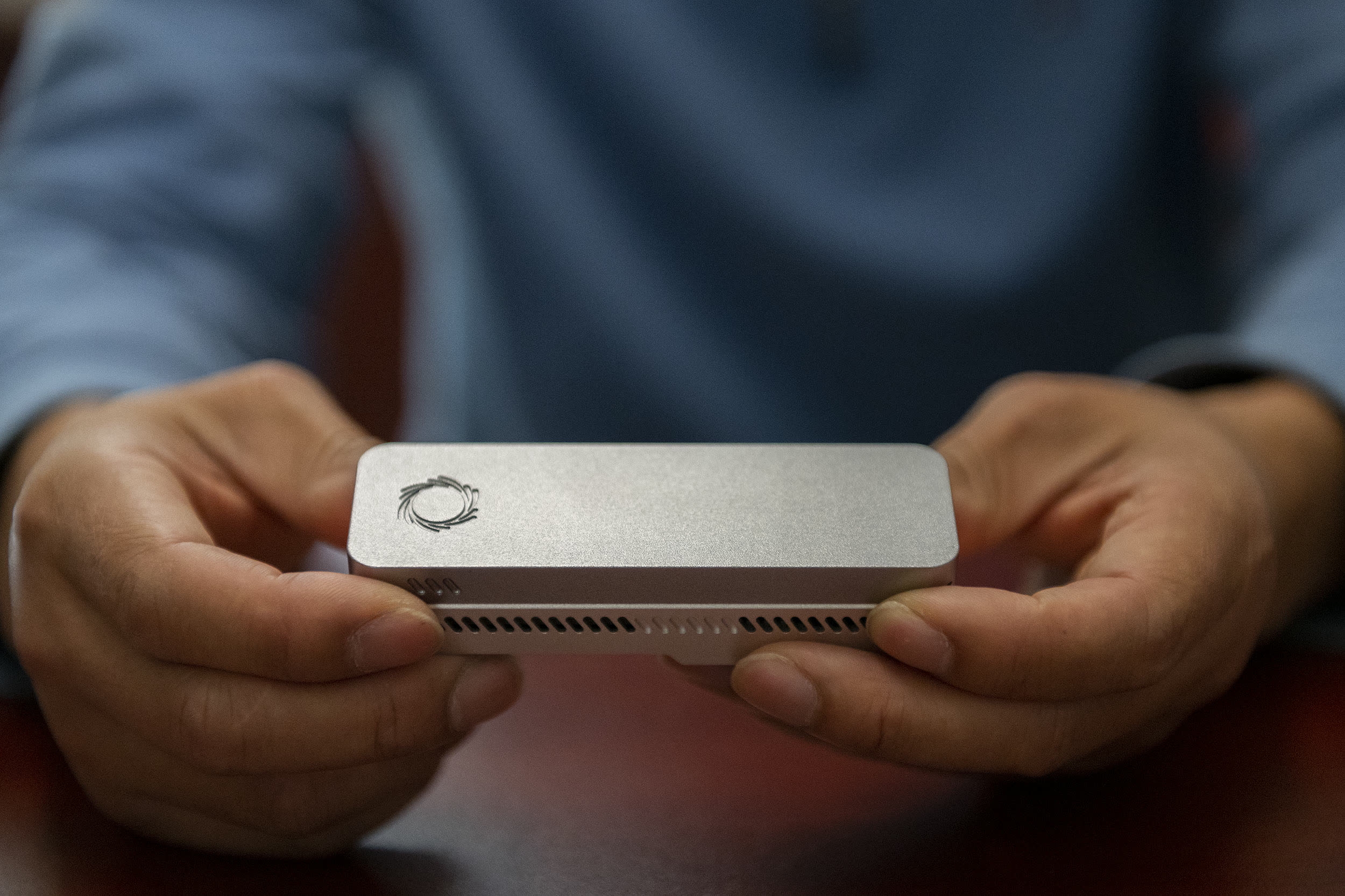 Hands holding a portable DNA sequencing device in the field